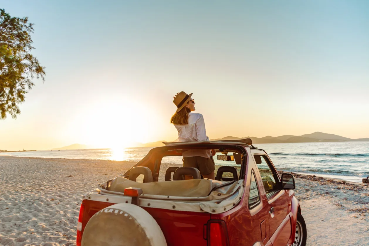 woman enjoying seaside from convertable mindful travel concept